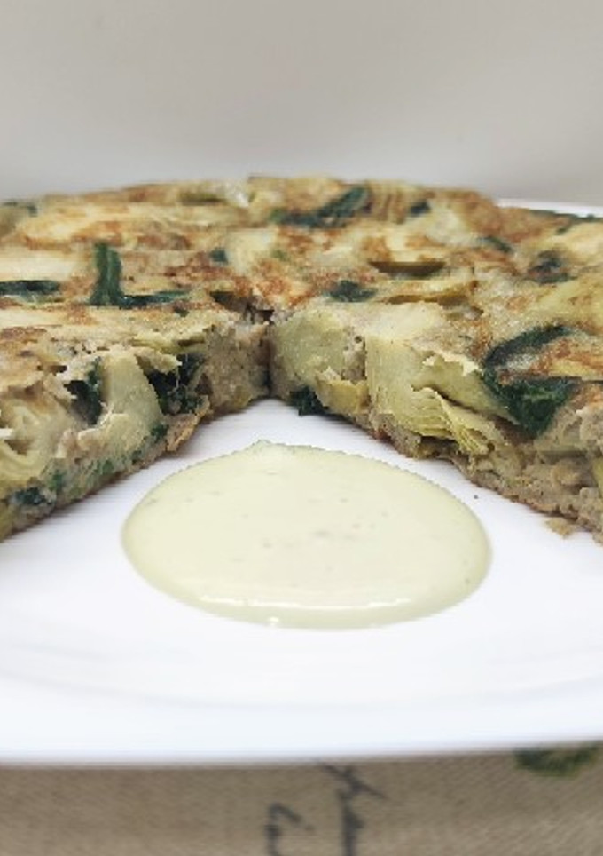 Una foto de Tortilla de alcachofas y espinacas con alioli de aguacate