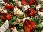 Una foto de ensalada de rúcula y fresa