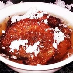 A picture of Chhena Malpua dipped with sugar syrup.