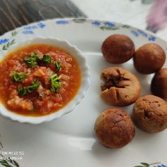 A picture of Bati in Appam Maker with Tomato Chokha.