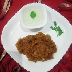 A picture of Aloo burji with coriander-mint curd.