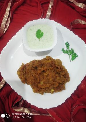 A picture of Aloo burji with coriander-mint curd.