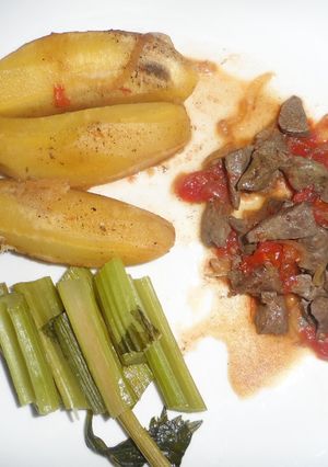 A picture of Matoke served with liver and Celery stalks.