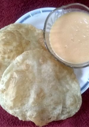 A picture of Aam rus with puri.