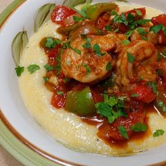 A picture of Spicy shrimp over creamy polenta.