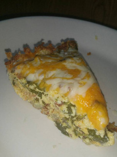 A picture of Spinach & Bacon Quiche with hash brown crust.