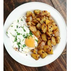 A picture of Fried potatoes and egg -breakfast.