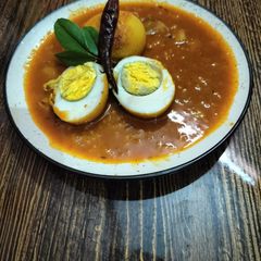 A picture of Tomato egg curry.