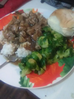 A picture of Pork Tips and Onions over White Rice.
