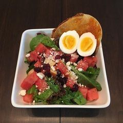 A picture of Spinach and Water Melon Salad  with  Tortilla Grilled Cheese.