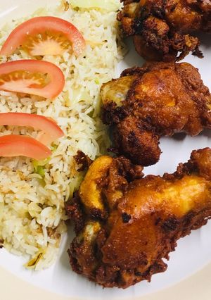 A picture of Garlic fried rice with crispy chicken wings.