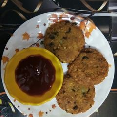 A picture of Crispy Poha cutlet with red sauce.