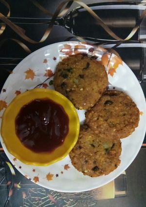A picture of Crispy Poha cutlet with red sauce.