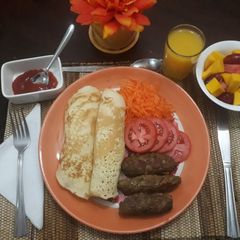 A picture of Mini beef kebabs with pancakes and salad.