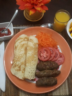 A picture of Mini beef kebabs with pancakes and salad.