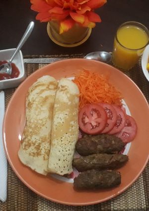 A picture of Mini beef kebabs with pancakes and salad.