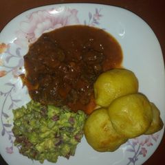A picture of Fried beef and deep fried potatoes with kachumbari.