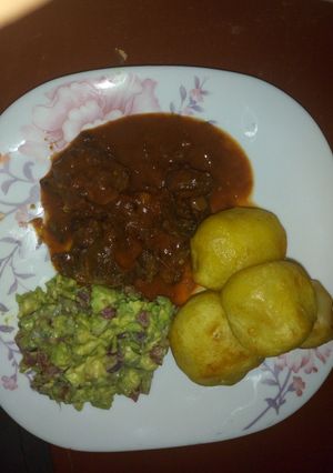 A picture of Fried beef and deep fried potatoes with kachumbari.
