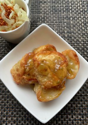 A picture of Fried Dumplings with Garlic Scapes and Green Chili Sauce.