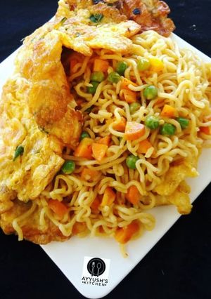 A picture of Jollof Vegetable noodles with fried eggs.