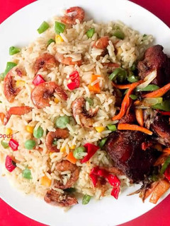 A picture of Coconut rice garnished with shrimps and vegetables.