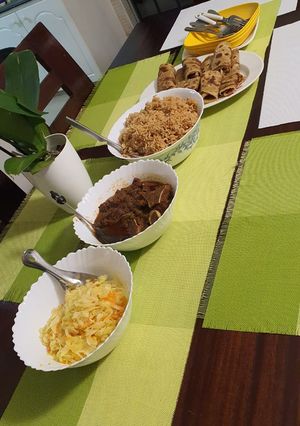 A picture of Pilau, beef stew, carroted cabbage and chapati.