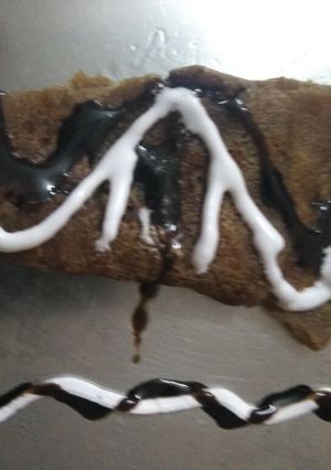 A picture of Jaggery pancake with chocolate syrup.