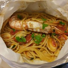 A picture of Spaghetti ai frutti di mare al cartoccio.