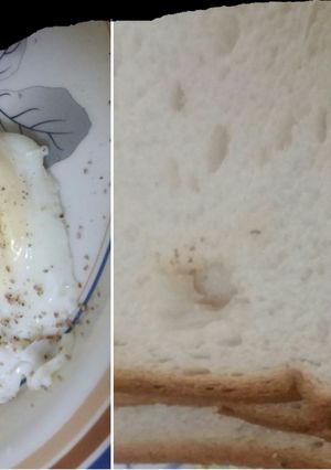 A picture of Half fried egg with bread for breakfast.