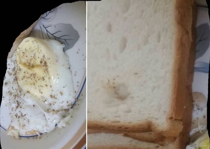 Half fried egg with  bread for breakfast
