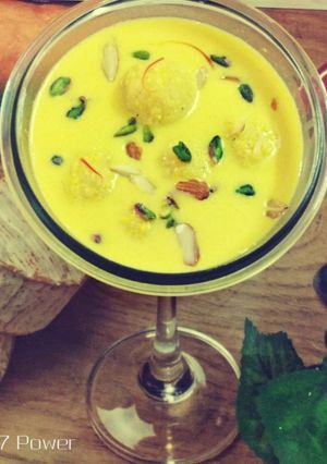 A picture of Coconut Mawa balls immersed in Creamy Coconut saffron milk.
