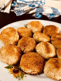 A picture of Narkol posto bora/ coconut poppyseed fritters.