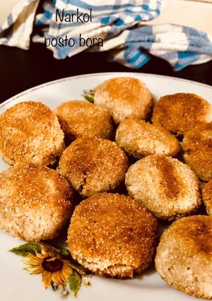 A picture of Narkol posto bora/ coconut poppyseed fritters.