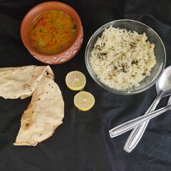 A picture of Dal tadka and jeera rice.