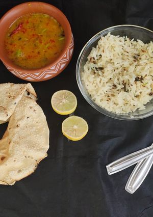 A picture of Dal tadka and jeera rice.