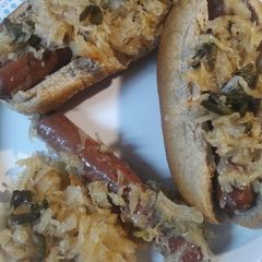 A picture of Sauerkraut, Hotdogs, and Peppers.