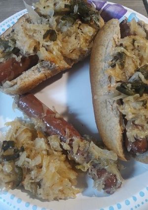 A picture of Sauerkraut, Hotdogs, and Peppers.
