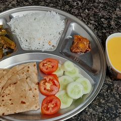 Simiple veg thali lunch with bhindi roti rice mango juice A picture of Simiple veg thali lunch with bhindi roti rice mango juice.
