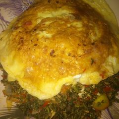 A picture of Spinach and egg source with fried egg.