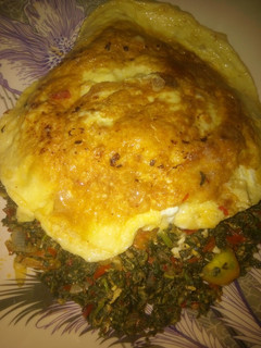 A picture of Spinach and egg source with fried egg.