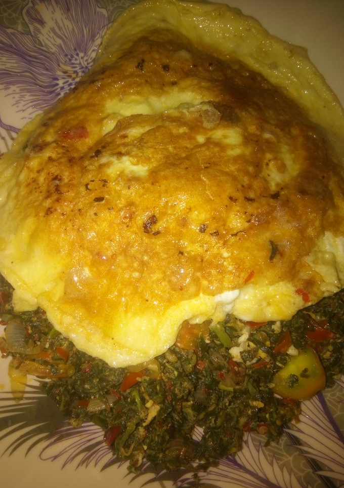 A picture of Spinach and egg source with fried egg.