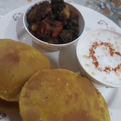 A picture of Achari besan aloo with Masala puri.