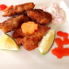 A picture of Marinated fish with tartare sauce.