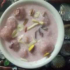 A picture of Chenna balls in rose milk sauce.