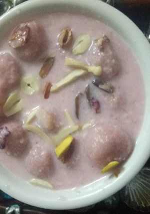 A picture of Chenna balls in rose milk sauce.