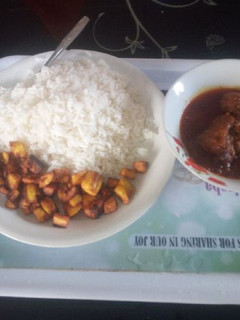 A picture of White and stew with fried plantain.