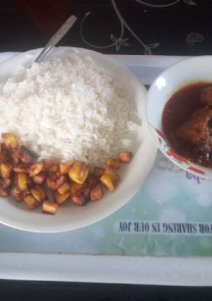 A picture of White and stew with fried plantain.