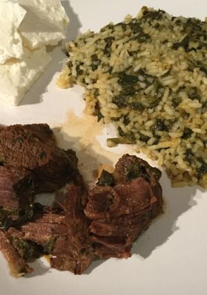 A picture of Pork with spinach rice & greek feta.