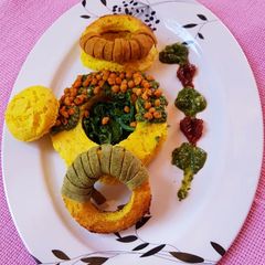A picture of Baked dhokla doughnuts with spinach sauce.