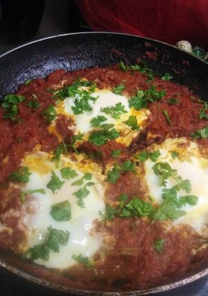 A picture of Shakshuka with meethi lassi.